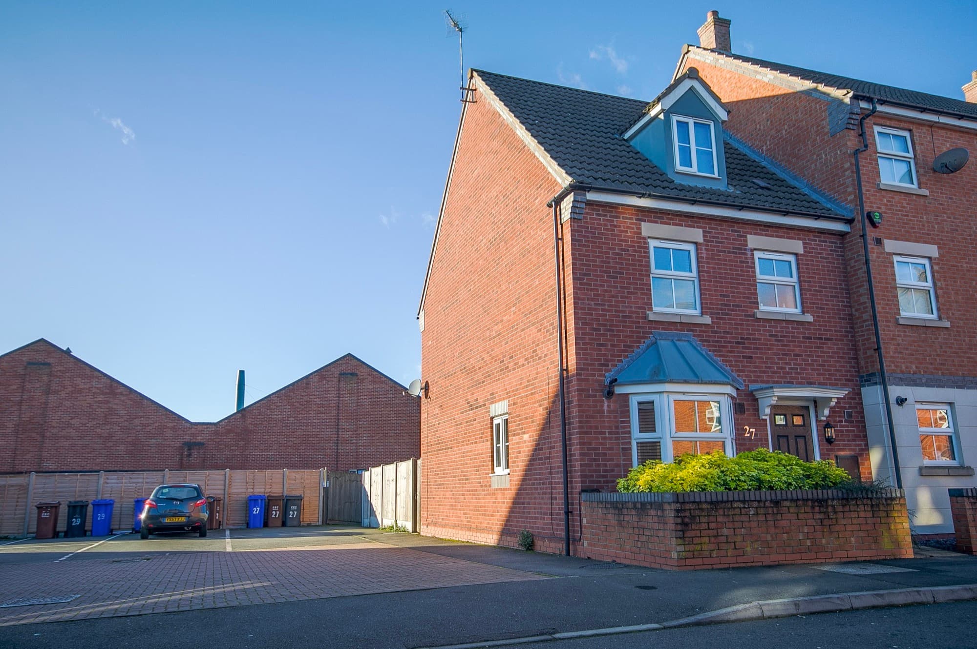 Short-let property exterior in Derbyshire with driveway and red brickwork